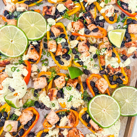 Eat Fit Pepper Nachos - Mini sweet peppers topped with chili-lime chicken, black beans, white cheddar, and green onions, finished with avocado sour cream and fresh lime