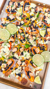 Eat Fit Pepper Nachos - Mini sweet peppers topped with chili-lime chicken, black beans, white cheddar, and green onions, finished with avocado sour cream and fresh lime
