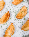 Southwest Chicken &amp; Queso Hand Pies - Flaky, golden pastry filled with southwest seasoned chicken, white queso and lime crema for dipping sauce
