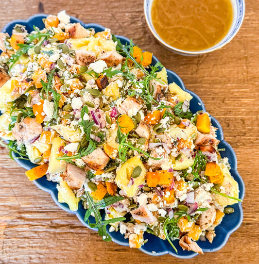 Roasted Squash Pasta Salad - Roasted squash, pepitas, and goat cheese combined with grilled chicken, shallots, baby arugula, and tender tortellini, all tossed in a rich brown butter vinaigrette.