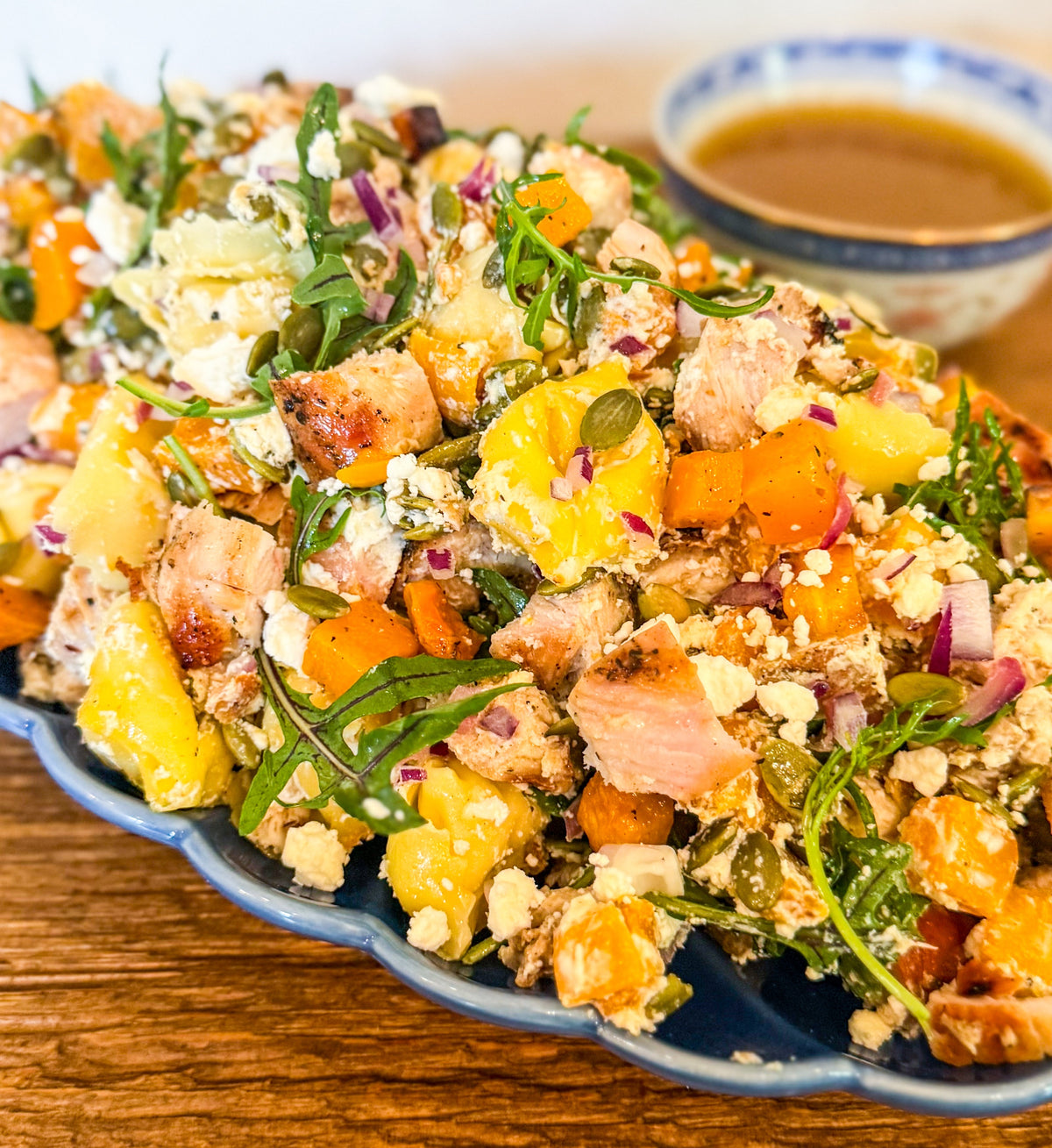 Roasted Squash Pasta Salad - Roasted squash, pepitas, and goat cheese combined with grilled chicken, shallots, baby arugula, and tender tortellini, all tossed in a rich brown butter vinaigrette.