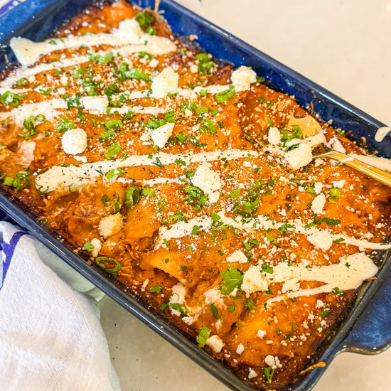 Chicken &amp; Butternut Squash Enchilada Bake - Tender chicken, roasted butternut squash, Mexican cheese and golden enchilada sauce wrapped in tortillas and topped with crumbly cotija cheese and herb crema