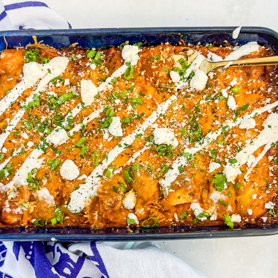 Chicken &amp; Butternut Squash Enchilada Bake - Tender chicken, roasted butternut squash, Mexican cheese and golden enchilada sauce wrapped in tortillas and topped with crumbly cotija cheese and herb crema