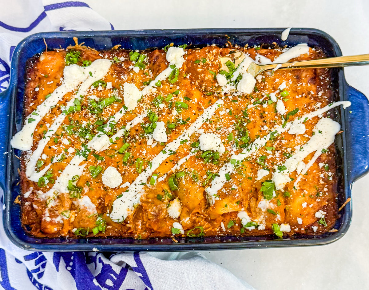 Chicken &amp; Butternut Squash Enchilada Bake - Tender chicken, roasted butternut squash, Mexican cheese and golden enchilada sauce wrapped in tortillas and topped with crumbly cotija cheese and herb crema