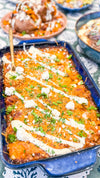 Chicken &amp; Butternut Squash Enchilada Bake - Tender chicken, roasted butternut squash, Mexican cheese and golden enchilada sauce wrapped in tortillas and topped with crumbly cotija cheese and herb crema