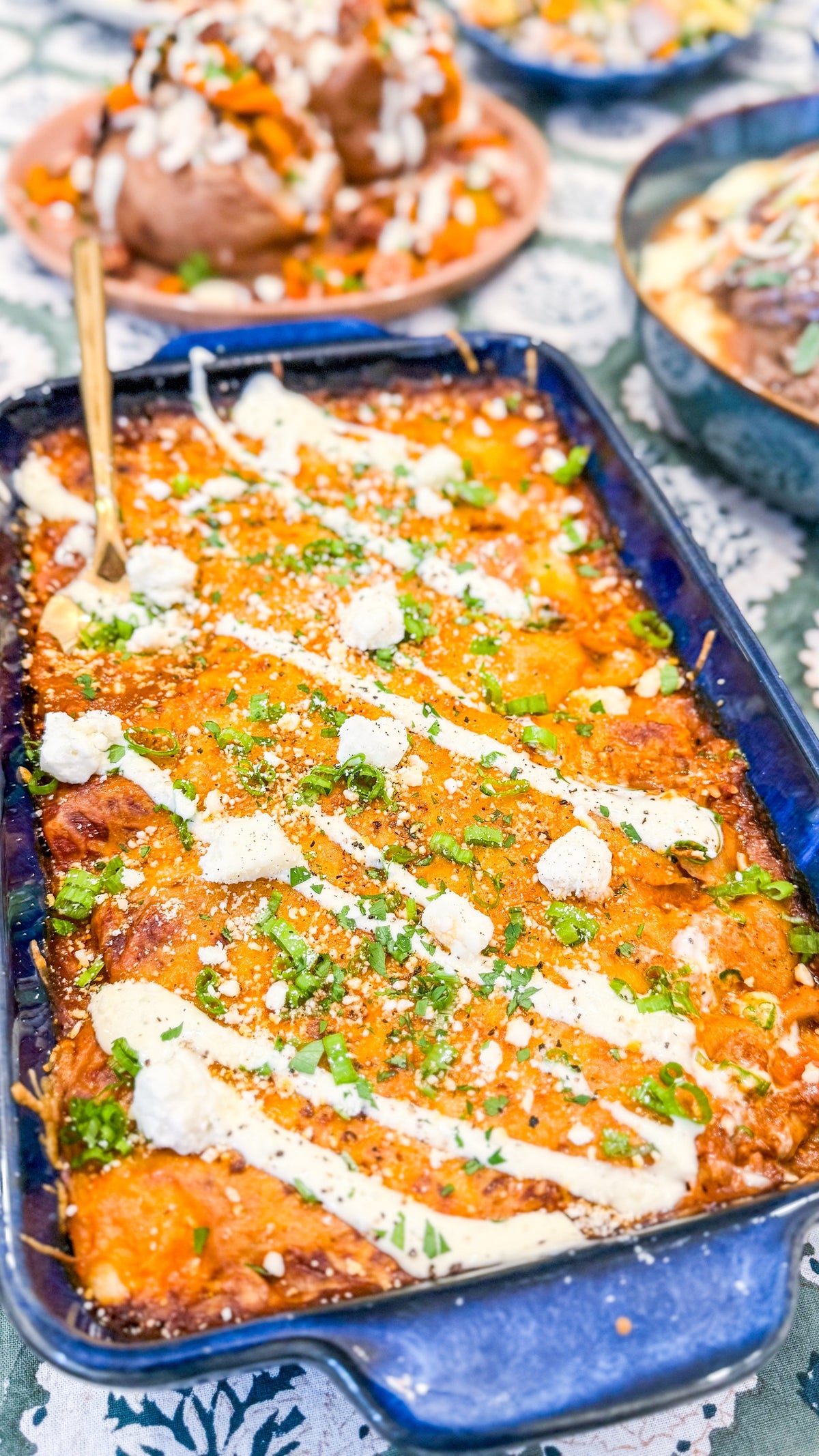Chicken &amp; Butternut Squash Enchilada Bake - Tender chicken, roasted butternut squash, Mexican cheese and golden enchilada sauce wrapped in tortillas and topped with crumbly cotija cheese and herb crema