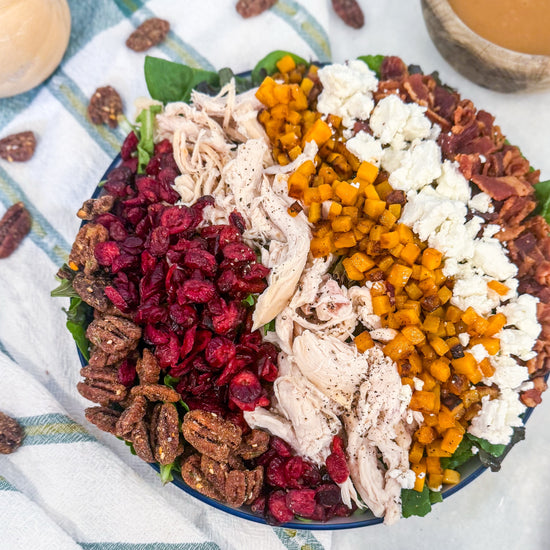 Harvest Cobb - Cider-brined grilled chicken, mixed greens, roasted butternut squash, dried cranberries, spiced pecans, goat cheese, bacon, and maple-Dijon dressing
