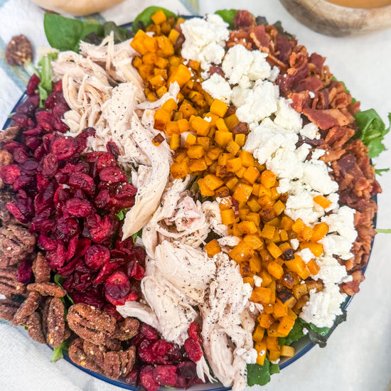 Harvest Cobb - Cider-brined grilled chicken, mixed greens, roasted butternut squash, dried cranberries, spiced pecans, goat cheese, bacon, and maple-Dijon dressing