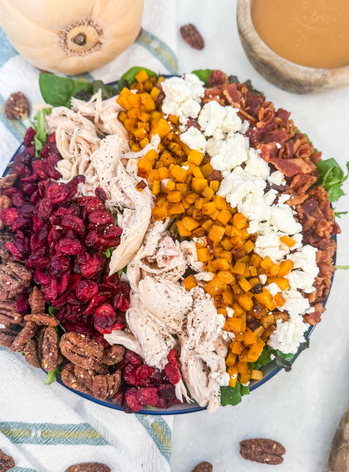 Harvest Cobb - Cider-brined grilled chicken, mixed greens, roasted butternut squash, dried cranberries, spiced pecans, goat cheese, bacon, and maple-Dijon dressing