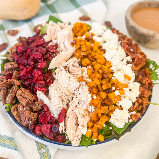 Harvest Cobb - Cider-brined grilled chicken, mixed greens, roasted butternut squash, dried cranberries, spiced pecans, goat cheese, bacon, and maple-Dijon dressing
