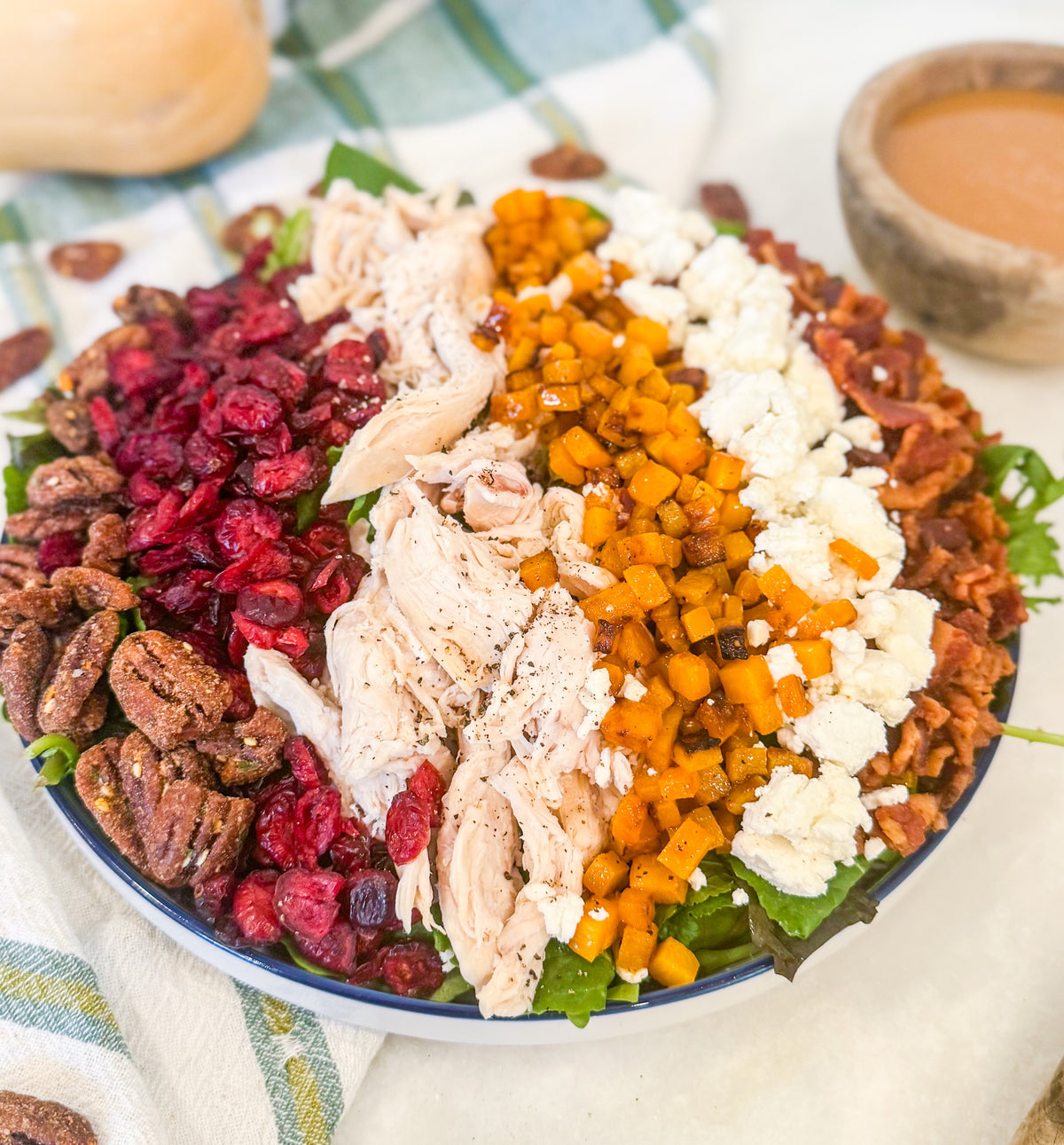 Harvest Cobb - Cider-brined grilled chicken, mixed greens, roasted butternut squash, dried cranberries, spiced pecans, goat cheese, bacon, and maple-Dijon dressing