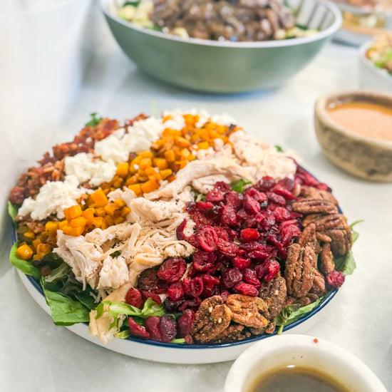Harvest Cobb - Cider-brined grilled chicken, mixed greens, roasted butternut squash, dried cranberries, spiced pecans, goat cheese, bacon, and maple-Dijon dressing