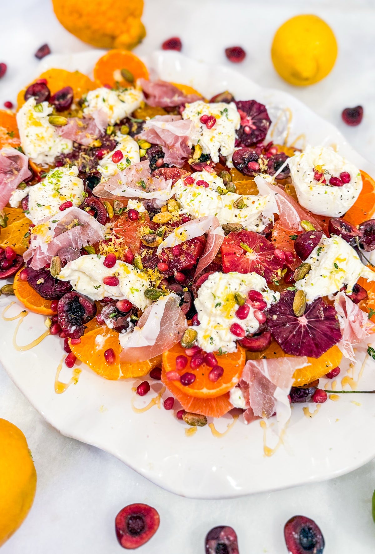 Eat Fit Seasonal Fruit &amp; Burrata Bowl - Cherries and citrus with burrata, prosciutto, pomegranate, pistachios, thyme, fresh herbs, honey, and grilled Eat Fit approved bread