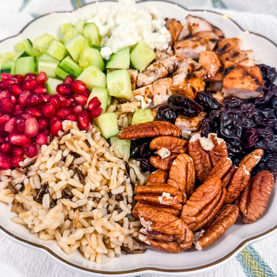 Autumn Wild Rice Bowl - Fig-butter grilled chicken, wild rice, dried cherries, pomegranate seeds, cucumbers, toasted pecans, goat cheese, blood-orange balsamic glaze
