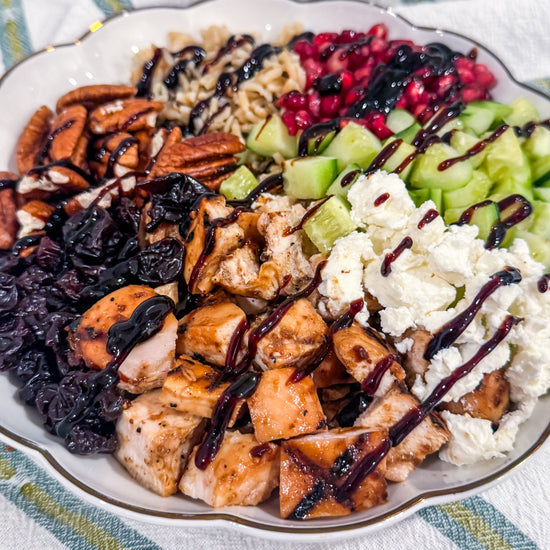 Autumn Wild Rice Bowl - Fig-butter grilled chicken, wild rice, dried cherries, pomegranate seeds, cucumbers, toasted pecans, goat cheese, blood-orange balsamic glaze