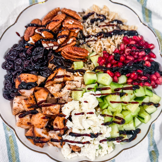 Autumn Wild Rice Bowl - Fig-butter grilled chicken, wild rice, dried cherries, pomegranate seeds, cucumbers, toasted pecans, goat cheese, blood-orange balsamic glaze