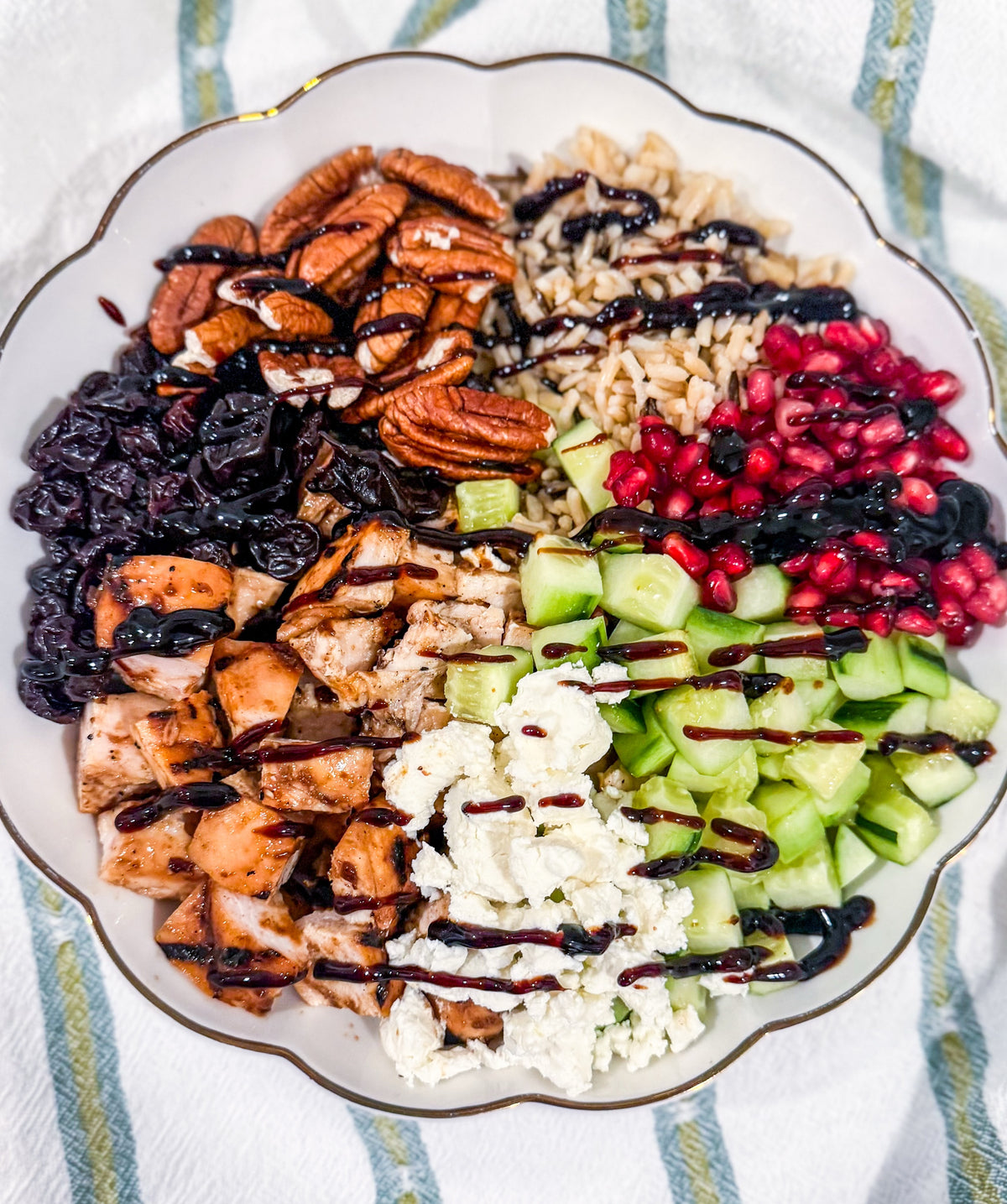 Autumn Wild Rice Bowl - Fig-butter grilled chicken, wild rice, dried cherries, pomegranate seeds, cucumbers, toasted pecans, goat cheese, blood-orange balsamic glaze