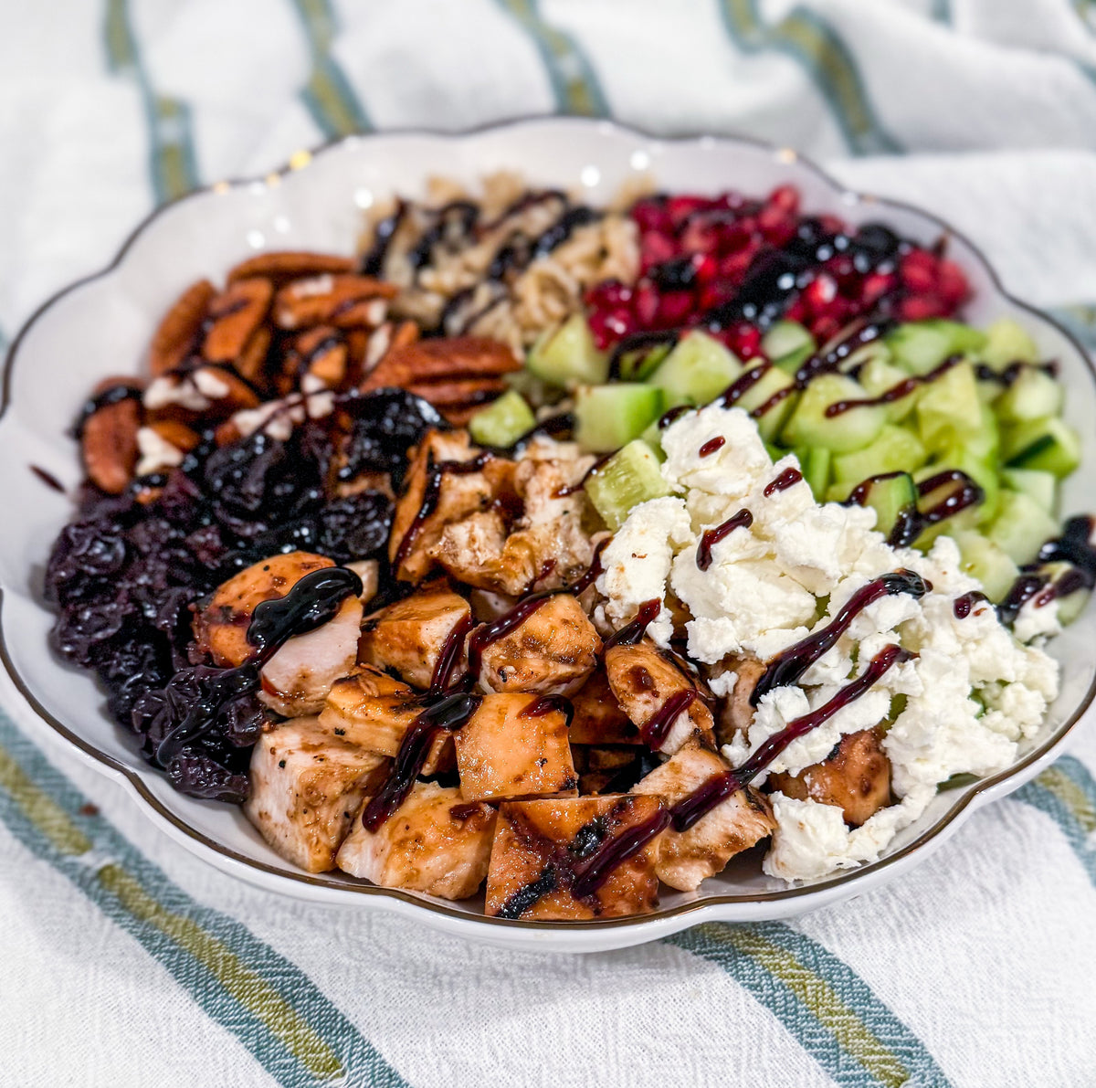 Autumn Wild Rice Bowl - Fig-butter grilled chicken, wild rice, dried cherries, pomegranate seeds, cucumbers, toasted pecans, goat cheese, blood-orange balsamic glaze