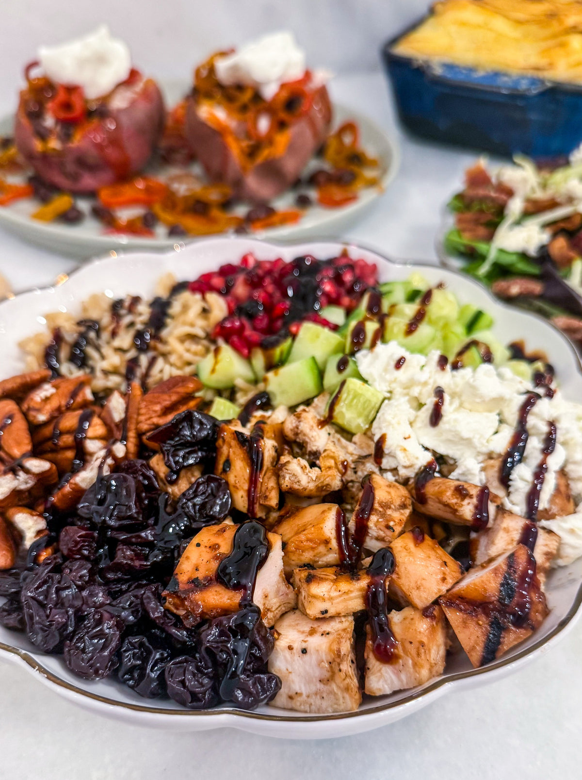Autumn Wild Rice Bowl - Fig-butter grilled chicken, wild rice, dried cherries, pomegranate seeds, cucumbers, toasted pecans, goat cheese, blood-orange balsamic glaze